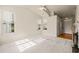 Bright living room features neutral walls, carpet, and natural light from the windows at 1116 Silky Dogwood Trl, Apex, NC 27502