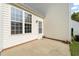 An exterior shot showcasing a patio area and the house's side with an access door and window at 1116 Silky Dogwood Trl, Apex, NC 27502