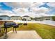 Spacious backyard with lush green grass, a patio, and a grill, perfect for outdoor entertaining at 112 Willow Grove Ln, Fuquay Varina, NC 27526