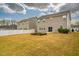 Expansive backyard with a grill, garden beds, privacy fence, and view of the rear of adjacent homes at 112 Willow Grove Ln, Fuquay Varina, NC 27526