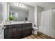 Bathroom featuring a single vanity with dark cabinets, a toilet, and a shower with a white curtain at 112 Willow Grove Ln, Fuquay Varina, NC 27526
