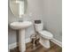 Powder room featuring pedestal sink and toilet at 112 Willow Grove Ln, Fuquay Varina, NC 27526