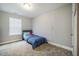 Cozy bedroom with neutral walls, carpet flooring, and a window with blinds allowing natural light at 112 Willow Grove Ln, Fuquay Varina, NC 27526