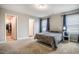 Primary bedroom featuring carpet, windows with coverings, and neutral paint at 112 Willow Grove Ln, Fuquay Varina, NC 27526
