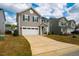 Charming two-story home with a two-car garage and a well-maintained front lawn and long driveway at 112 Willow Grove Ln, Fuquay Varina, NC 27526