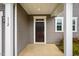Inviting front door entrance with white trim and columns, offering a warm welcome to guests at 112 Willow Grove Ln, Fuquay Varina, NC 27526