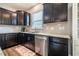 Kitchen features dark wood cabinets, stainless steel appliances, and granite countertops, creating a modern feel at 112 Willow Grove Ln, Fuquay Varina, NC 27526