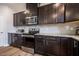 Modern kitchen features stainless steel appliances, granite counters, subway tile backsplash and dark cabinets at 112 Willow Grove Ln, Fuquay Varina, NC 27526