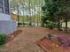Expansive backyard with mature trees, landscaping, and view of the lake at 117 Linwood Ln, Clayton, NC 27527