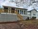 This backyard features a large deck, screened-in porch, and stairs leading to the grassy lawn at 117 Linwood Ln, Clayton, NC 27527