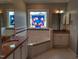 A spacious bathroom features a soaking tub, granite countertops, and a decorative stained-glass window at 117 Linwood Ln, Clayton, NC 27527