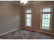 This bedroom has neutral paint, plush carpet, and two windows offering ample natural light at 117 Linwood Ln, Clayton, NC 27527