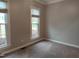 This bedroom features neutral paint, plush carpet, and a large window for plenty of natural light at 117 Linwood Ln, Clayton, NC 27527