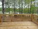 Wooden deck featuring a beautiful view of the lake and golf course in the backyard at 117 Linwood Ln, Clayton, NC 27527