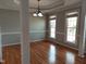 Elegant dining room featuring hardwood floors, decorative columns, and ample natural light from large windows at 117 Linwood Ln, Clayton, NC 27527