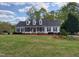 A white home with black shutters and a well-kept lawn creates a welcoming curb appeal at 117 Linwood Ln, Clayton, NC 27527