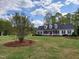 Charming white home with black shutters, dormer windows, and a well-manicured lawn at 117 Linwood Ln, Clayton, NC 27527