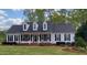 Charming single-story home with a welcoming front porch and beautiful landscaping at 117 Linwood Ln, Clayton, NC 27527