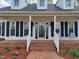 Charming front porch with traditional design, decorative chairs, and manicured landscaping enhancing curb appeal at 117 Linwood Ln, Clayton, NC 27527