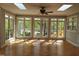 Sunroom with multiple windows showcasing picturesque views of the surrounding greenery at 117 Linwood Ln, Clayton, NC 27527
