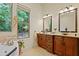 Bathroom features dual sinks, custom cabinets, and large window with natural light at 1217 Mauldin Rd, Wake Forest, NC 27587