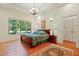 Beautiful bedroom featuring hardwood floors, natural light, and chandelier at 1217 Mauldin Rd, Wake Forest, NC 27587
