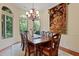 Formal dining room featuring a large table, ornate chandelier, and scenic outdoor views at 1217 Mauldin Rd, Wake Forest, NC 27587