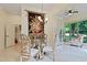 Bright dining area with chandelier, modern chairs, and access to sunroom at 1217 Mauldin Rd, Wake Forest, NC 27587