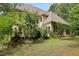 Beautiful home exterior with lush greenery offering a serene and private setting at 1217 Mauldin Rd, Wake Forest, NC 27587