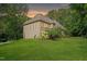 Beautiful tan two-story home with green lawn and surrounding trees at 1217 Mauldin Rd, Wake Forest, NC 27587