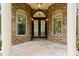 Elegant front entrance with stone accents, arched transom, and decorative double doors at 1217 Mauldin Rd, Wake Forest, NC 27587