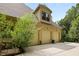 Three-car garage with ample parking space and an upper-level dormer window providing natural light at 1217 Mauldin Rd, Wake Forest, NC 27587
