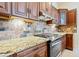 Gourmet kitchen features custom cabinets, granite counters, and stainless steel appliances at 1217 Mauldin Rd, Wake Forest, NC 27587