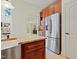 Open kitchen with stainless steel fridge, custom cabinets, and granite island at 1217 Mauldin Rd, Wake Forest, NC 27587