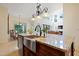 Kitchen island featuring granite countertop, stainless steel sink and dining area at 1217 Mauldin Rd, Wake Forest, NC 27587