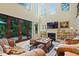 Bright living room with fireplace, high ceilings and views of the backyard through sliding glass doors at 1217 Mauldin Rd, Wake Forest, NC 27587