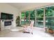 Comfortable living room features fireplace, tile floors, large windows and backyard views at 1217 Mauldin Rd, Wake Forest, NC 27587