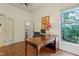 Spacious home office featuring a large desk, hardwood floors, and natural light at 1217 Mauldin Rd, Wake Forest, NC 27587