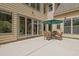 Charming outdoor patio featuring a dining set with umbrella and seamless access to the home through sliding glass doors at 1217 Mauldin Rd, Wake Forest, NC 27587