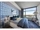 Modern bedroom with a large window, stylish wallpaper, and chic furnishings at 122 N Harrington St # 775, Raleigh, NC 27603