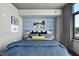 Modern bedroom with a large window, stylish wallpaper, and chic furnishings at 122 N Harrington St # 775, Raleigh, NC 27603