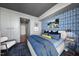 Modern bedroom featuring blue wallpaper, king bed, and closet access at 122 N Harrington St # 775, Raleigh, NC 27603