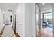Hallway with hardwood floors, a mirror, and an entryway to a bedroom at 122 N Harrington St # 775, Raleigh, NC 27603