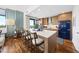 Chic kitchen island featuring modern appliances, a breakfast bar, and natural light from large windows at 122 N Harrington St # 775, Raleigh, NC 27603