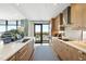 Well-lit kitchen with wooden cabinets, stainless steel appliances, and a blue-and-white rug at 122 N Harrington St # 775, Raleigh, NC 27603