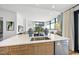 Modern kitchen featuring stainless steel appliances, wood cabinetry, and a white countertop with a sink at 122 N Harrington St # 775, Raleigh, NC 27603