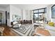 Stylish living room with contemporary furniture, hardwood floors, and large windows with city views at 122 N Harrington St # 775, Raleigh, NC 27603