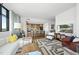 Open-concept living space with hardwood floors connecting to a modern kitchen and featuring large windows at 122 N Harrington St # 775, Raleigh, NC 27603