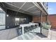 Stylish covered patio boasts a modern dining set, sleek finishes, and a relaxed atmosphere for outdoor enjoyment at 122 N Harrington St # 775, Raleigh, NC 27603