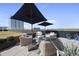 Inviting rooftop terrace with woven furniture, sun umbrellas, and stylish decor, offering a perfect outdoor retreat at 122 N Harrington St # 775, Raleigh, NC 27603
